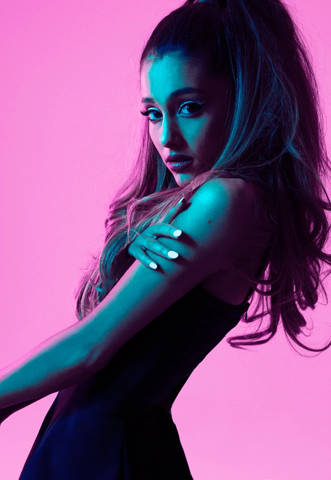 Grammy-winning singer-songwriter Ariana Grande, high ponytail, arms crossed, teal-pink neon light, photo by Austin Hargrave