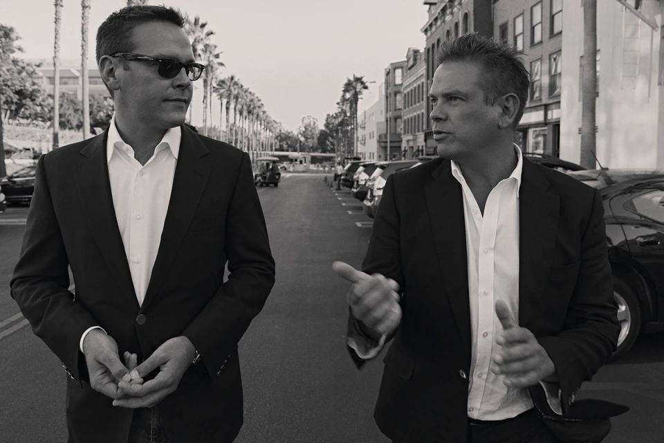 Media heirs Lachlan and James Murdoch mid-conversation on Fox backlot Los Angeles, photographed by Austin Hargrave
