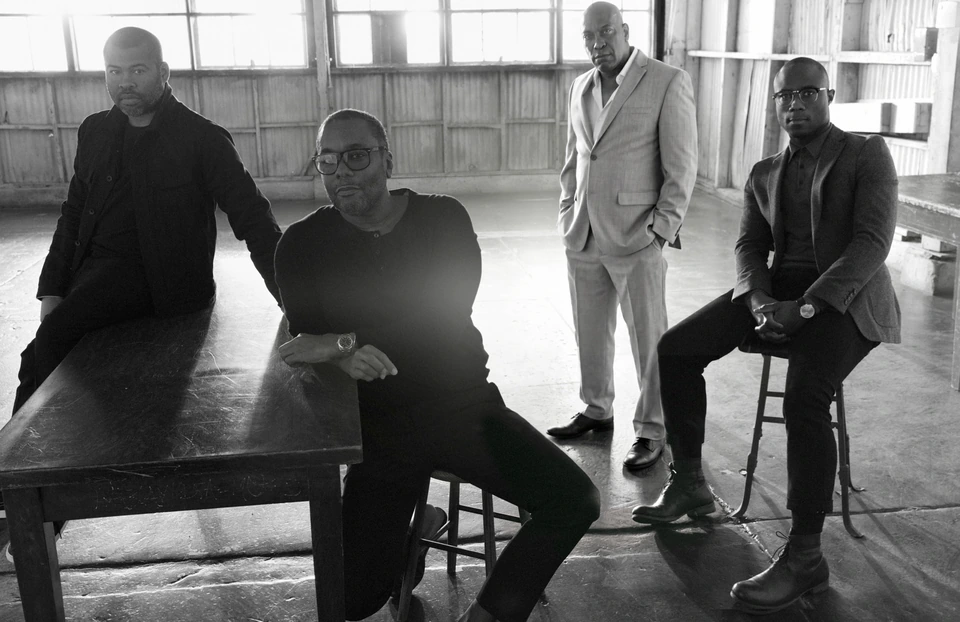 Iconic Black Directors Jordan Peele, Steve McQueen, John Singleton, and Barry Jenkins in black and white, empty warehouse.