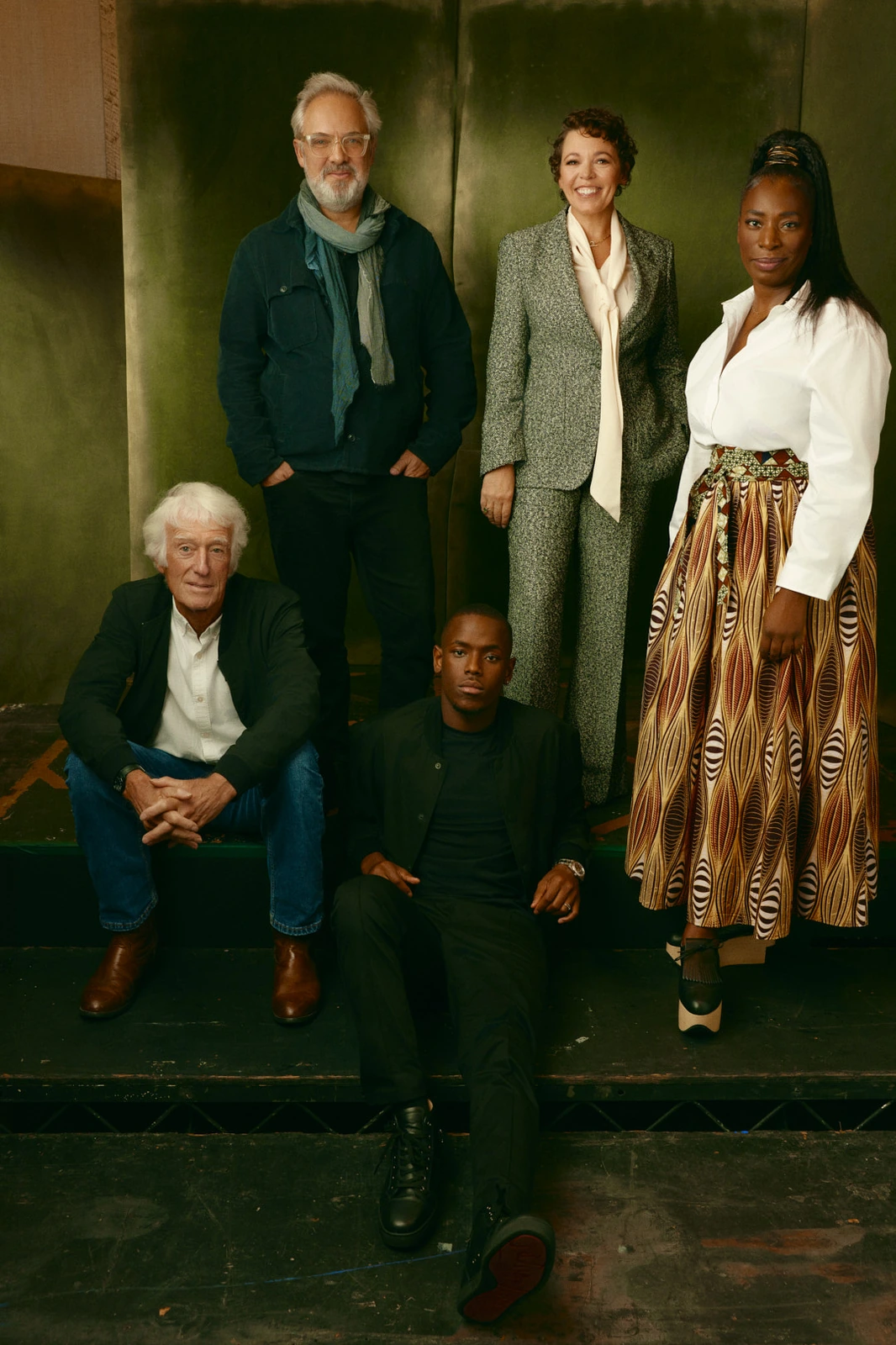 Roger Deakins, Sam Mendes, Olivia Colman, Tanya Moodie, and Michael Ward grouped on steps against a moody green wall, TIFF.