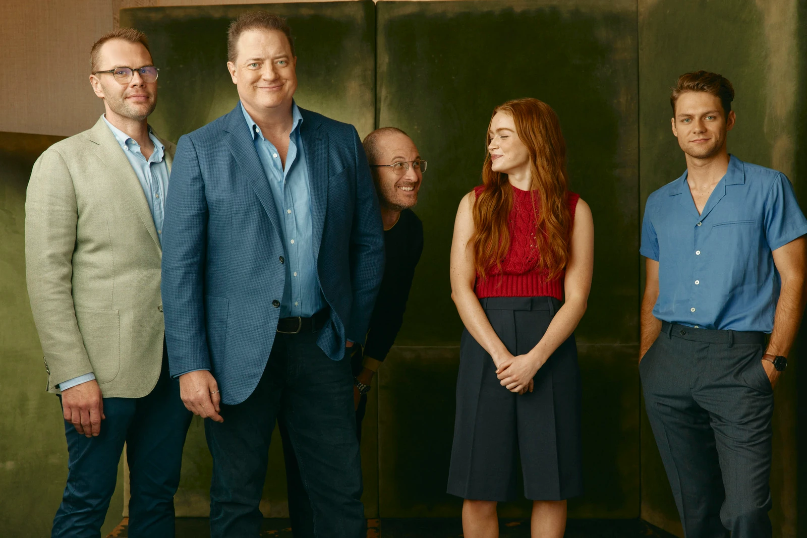 Samuel D. Hunter, Brendan Fraser, Darren Aronofsky, Sadie Sink, Ty Simpkins laughing together against a deep green wall.