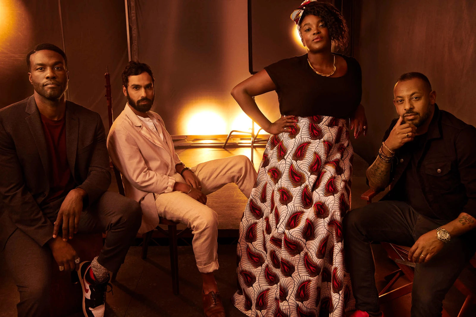 Actors Yahya Abdul-Mateen II, Kunal Nayyar, Wunmi Mosaku and Zeresenay Mehari bathed in warm amber studio light at TIFF.